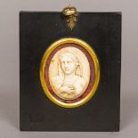 A 19th century carved ivory panel Of oval form, carved as the Virgin Mary,