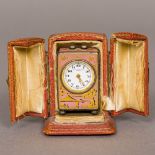 A Swiss enamel decorated silver cased miniature carriage clock The white enamelled dial with Arabic