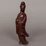 A Chinese carved wooden figure of Guanyin Typically modelled wearing flowing robes. 25.5 cm high.