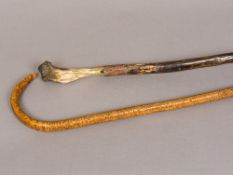 A bone handled hiking stick Together with a carved Folk Art walking stick. The latter 99 cm long.