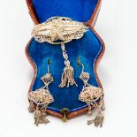 A cased set of Victorian silver filigree jewellery Comprising: a brooch with tassel drop and a pair