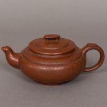 A Chinese Yixing pottery teapot The removable lid with horse form finial,