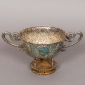 A 19th century Chinese silver twin handled bowl The florally embossed bowl with twin dragon handles