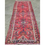 A red ground Hamadan runner 388 x 86 cm.