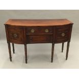 A Regency kingwood crossbanded ebony and satinwood line inlaid mahogany bow front sideboard The