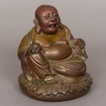 A 19th century Chinese patinated bronze figure of Buddha Typically modelled seated holding a peach.