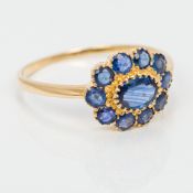 A Georgian style 9 ct gold sapphire ring Of flowerhead form. 1 cm high.