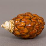 A nut form snuff bottle Set with bone collar and stopper. 6.5 cm high.