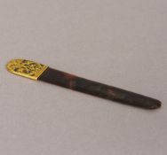 A 19th century unmarked gold mounted tortoiseshell letter opener Set with pierced scrolling foliate