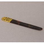 A 19th century unmarked gold mounted tortoiseshell letter opener Set with pierced scrolling foliate
