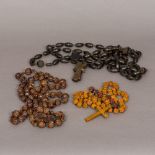 Three carved wooden sets of rosary beads The longest 150 cm long.