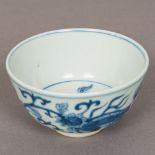 A Chinese blue and white porcelain bowl Decorated with shi-shi amongst floral scrollwork,