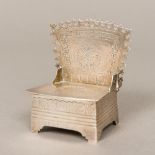 A small silver box Modelled as a chair, the seat hinged to form the box lid,