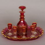 A Bohemian ruby flashed glass liqueur set Comprising: a decanter, tray and six liqueur glasses,