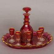 A Bohemian ruby flashed glass liqueur set Comprising: a decanter, tray and six liqueur glasses,