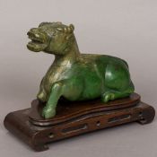 A large Chinese carved jade model of a ram Naturalistically modelled,