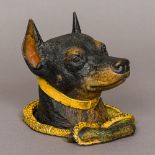 A cold painted bronze inkwell Formed as a dog's head inside an entwined riding crop. 14.5 cm high.