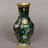 A famille noir cloisonne vase Of lobed bulbous form, decorated with various trailing foliage,