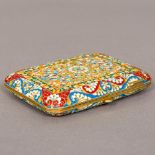 A champleve enamel and silver gilt cigarette case Decorated with scrolling floral sprays,