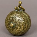 A 19th century Indian brass lime box Of typical circular form, with suspension loop. 8 cm high.
