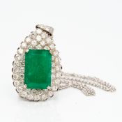 An 18 ct white gold diamond and emerald pendant Of pear drop form,