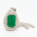 An 18 ct white gold diamond and emerald pendant Of pear drop form,