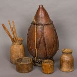 Four African tribal treen pots Together with an African gourd water carrier.
