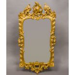 A late 18th/early 19th century carved giltwood and composition wall glass The arched scrolling