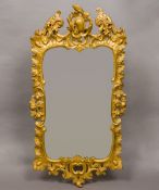 A late 18th/early 19th century carved giltwood and composition wall glass The arched scrolling