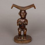 An African tribal carved wooden headrest With typical curved top above the double sided female