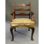 An 18th century mahogany ladder back open armchair The three curved back splats supported by carved
