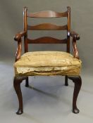 An 18th century mahogany ladder back open armchair The three curved back splats supported by carved