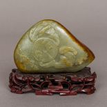 A Chinese jade boulder carving Decorated to one side with bats around a coin,