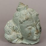 An Eastern carved stone bust Modelled as Buddha wearing a headdress. 14 cm high.