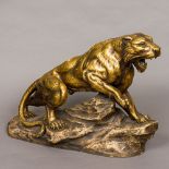 A Belgian bronzed terracotta model of a lion Modelled standing on a rocky outcrop, signed A FAGOTTO,