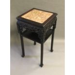 A late 19th century Chinese carved hardwood stand The square section top with marble inset above