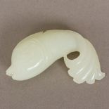 A Chinese carved celadon jade fish Naturalistically modelled. 8 cm long.
