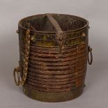 A 19th century Indian brass and iron mounted wooden grain measure With carved banded decoration.