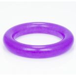 A lavender jade bangle Of plain circular form. 8.5 cm diameter.