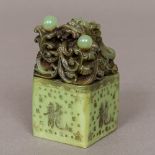 A Chinese carved green stone seal Of square section form,