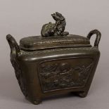 A Japanese Meiji period patinated bronze censer Of twin handled rounded rectangular form,