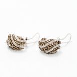 A pair of 14 ct white gold earrings Set with bands of white and champagne coloured diamonds.