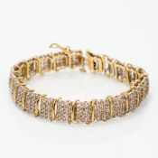 A 10K gold and diamond bracelet Of reticulated banded form, set with approximately 5.