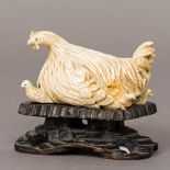 A late 19th/early 20th century Chinese carved ivory animalier group formed as a hen with
