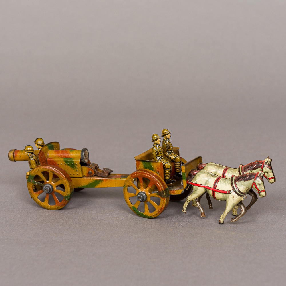 An early 20th century German artillery gun and horse drawn carriage 19.5 cm long.