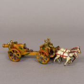 An early 20th century German artillery gun and horse drawn carriage 19.5 cm long.