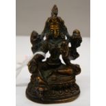 A small bronze deity. 6.5 cm high.