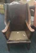 A late 19th/early 20th century leather armchair. 69 cm wide.