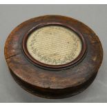 An early 19th century oak circular snuff box. 9 cm diameter.