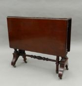 An Edwardian mahogany Sutherland table. 66 cm wide.